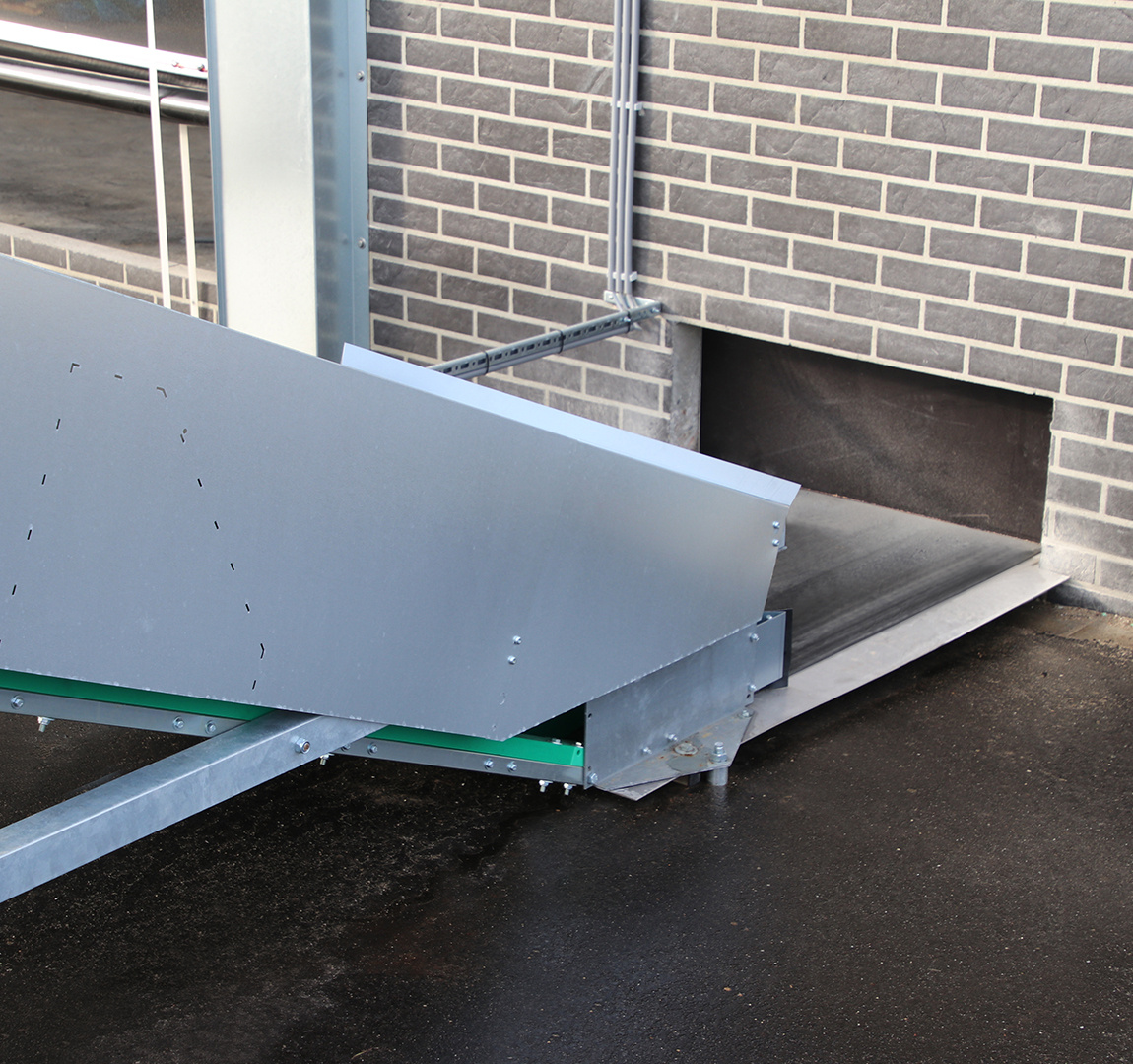 manure conveyor transfer point at livestock building